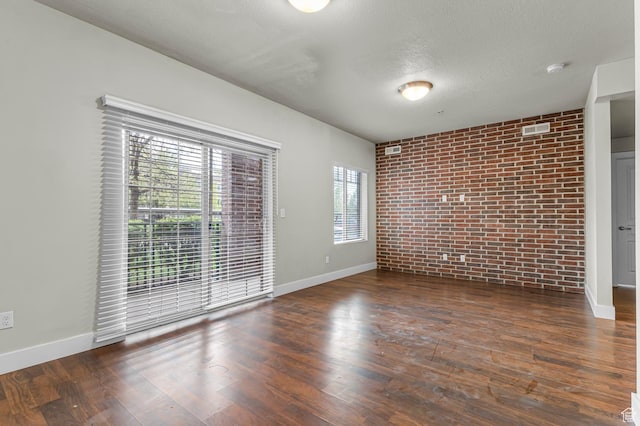 170 E Belmont Ave Unit 15, Salt Lake City, UT 84111 - unfurnished room with visible vents, baseboards, and brick wall