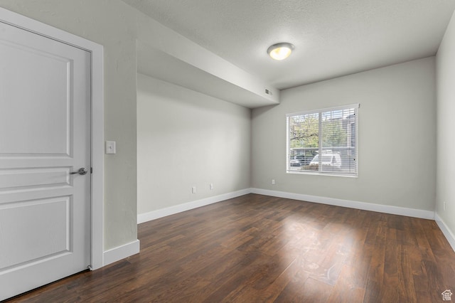 170 E Belmont Ave Unit 15, Salt Lake City, UT 84111 - empty room featuring dark wood-type flooring, a textured ceiling, baseboards, and visible vents