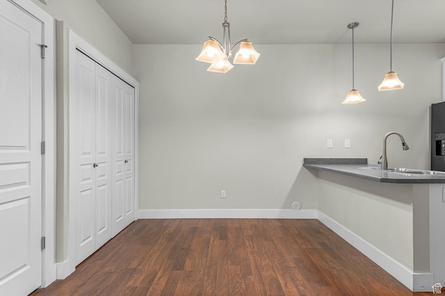 170 E Belmont Ave Unit 15, Salt Lake City, UT 84111 - kitchen featuring dark countertops, dark wood finished floors, baseboards, a peninsula, and a chandelier