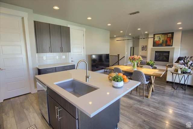 3159 N 1100 W, Pleasant View, UT 84414 - kitchen with wood finished floors, dishwasher, a sink, light countertops, and an island with sink