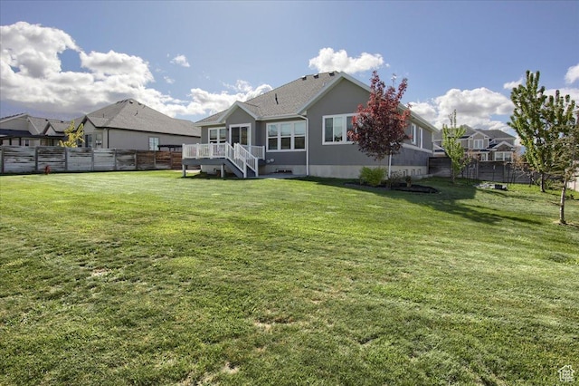 3159 N 1100 W, Pleasant View, UT 84414 - rear view of property featuring a lawn, a deck, stairway, and fence