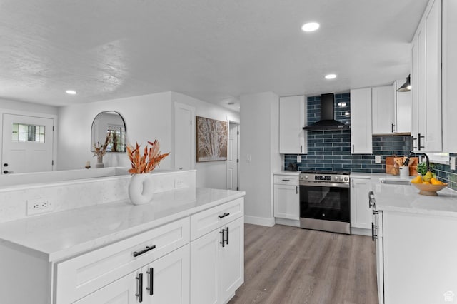 8671 S 3780 W, West Jordan, UT 84088 - kitchen featuring stainless steel electric range, a sink, light wood-style flooring, wall chimney exhaust hood, and backsplash
