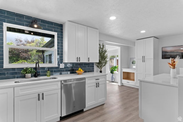 8671 S 3780 W, West Jordan, UT 84088 - kitchen featuring a textured ceiling, decorative backsplash, a sink, and dishwasher
