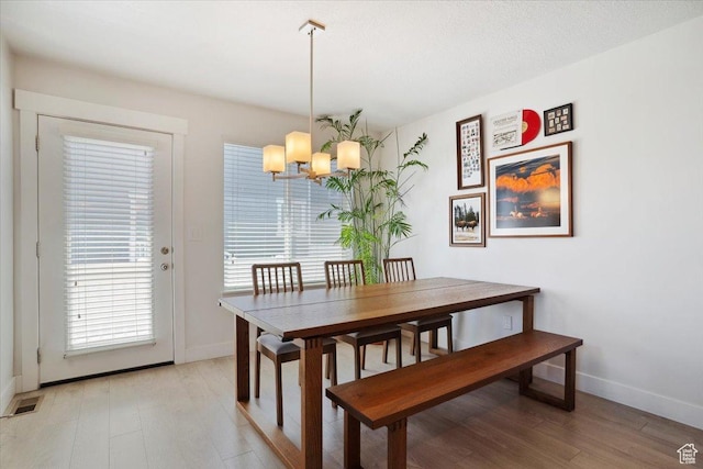 4101 W 1850 N, Lehi, UT 84043 - dining room featuring visible vents, light wood finished floors, baseboards, and a chandelier