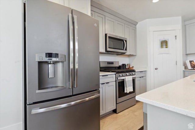 4101 W 1850 N, Lehi, UT 84043 - kitchen with light wood-style floors, gray cabinets, appliances with stainless steel finishes, and light stone countertops