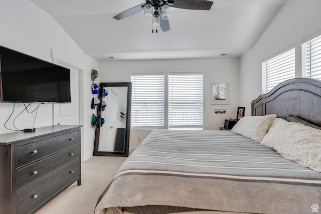 bedroom with a ceiling fan, multiple windows, vaulted ceiling, and light carpet
