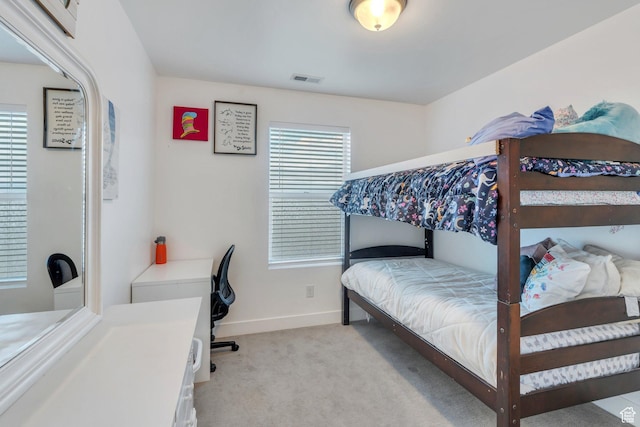 bedroom with light colored carpet, baseboards, and visible vents