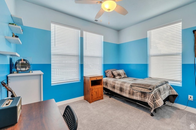 carpeted bedroom with a ceiling fan and baseboards
