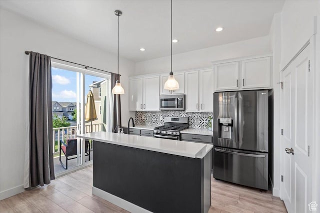 5233 W Linley Ct, Herriman, UT 84096 - kitchen with stainless steel appliances, backsplash, light wood finished floors, light countertops, and white cabinetry