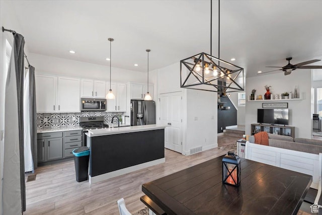 5233 W Linley Ct, Herriman, UT 84096 - living area featuring a ceiling fan, light wood-style flooring, recessed lighting, and a chandelier