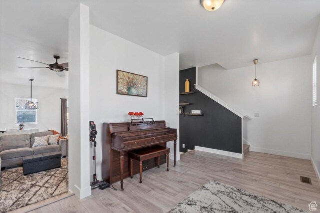 5233 W Linley Ct, Herriman, UT 84096 - living area with wood finished floors, a ceiling fan, and stairway