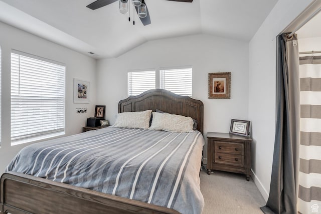 bedroom featuring a ceiling fan, baseboards, light colored carpet, and lofted ceiling