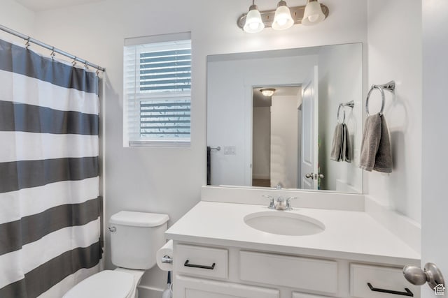 full bathroom with vanity, curtained shower, and toilet