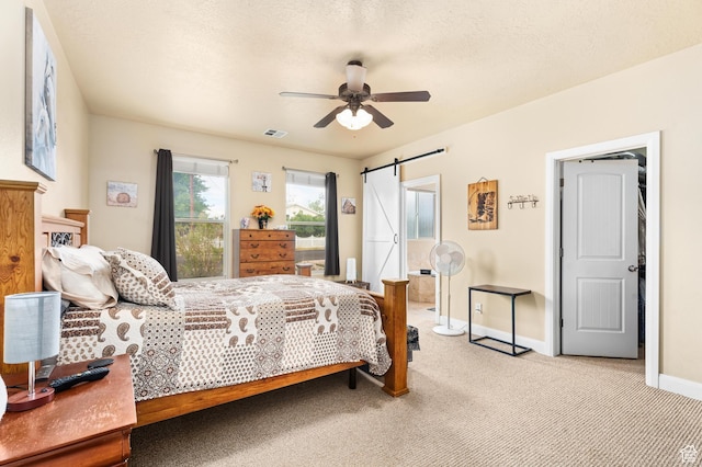 78 W Jolley Cir, Washington, UT 84780 - bedroom featuring a ceiling fan, visible vents, a barn door, baseboards, and light carpet