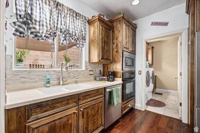 78 W Jolley Cir, Washington, UT 84780 - kitchen featuring a sink, light countertops, washing machine and dryer, stainless steel appliances, and dark wood-style floors
