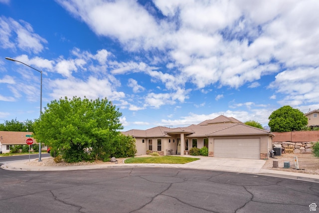 78 W Jolley Cir, Washington, UT 84780 - view of front of home with a tiled roof, driveway, a garage, fence, and stucco siding