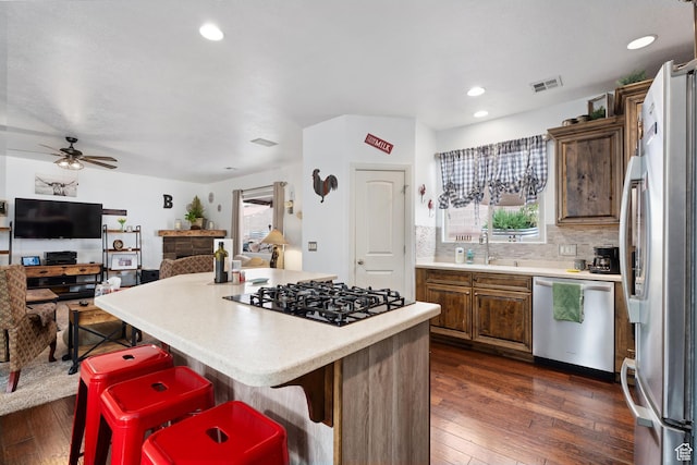 78 W Jolley Cir, Washington, UT 84780 - kitchen with light countertops, a center island, stainless steel appliances, dark wood-type flooring, and visible vents