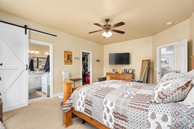 78 W Jolley Cir, Washington, UT 84780 - bedroom featuring light colored carpet, a barn door, a walk in closet, a ceiling fan, and a closet