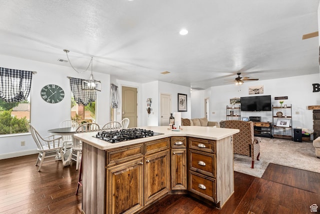 78 W Jolley Cir, Washington, UT 84780 - kitchen with light countertops, ceiling fan with notable chandelier, a center island, open floor plan, and gas stovetop