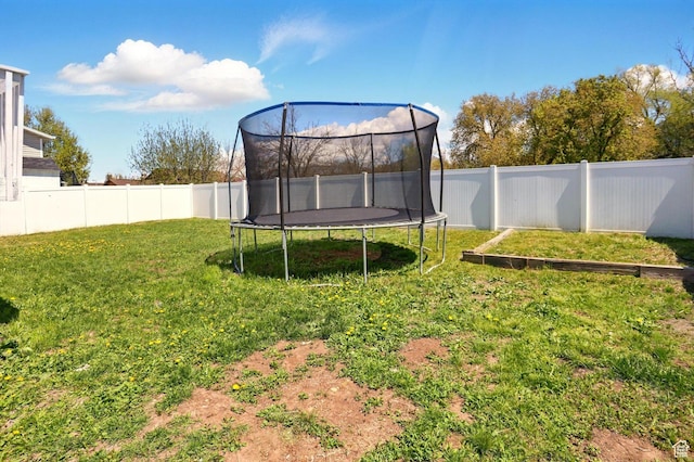 680 S Riverwalk Pkwy W, Logan, UT 84321 - view of yard with a fenced backyard and a trampoline