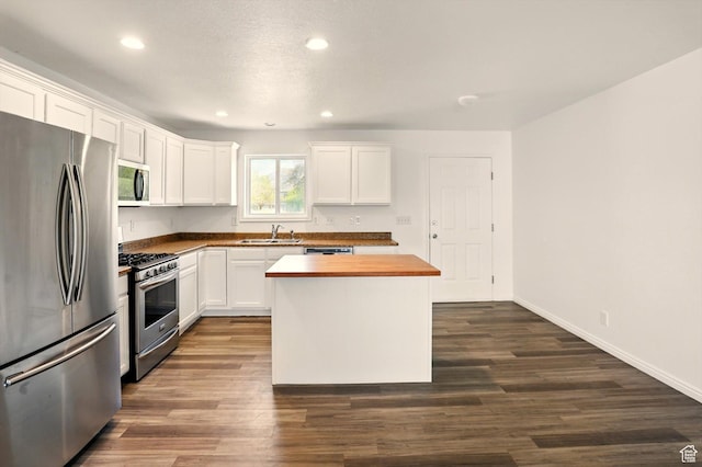 680 S Riverwalk Pkwy W, Logan, UT 84321 - kitchen with recessed lighting, white cabinetry, appliances with stainless steel finishes, and wooden counters
