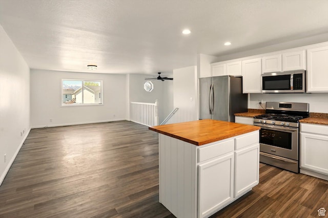 680 S Riverwalk Pkwy W, Logan, UT 84321 - kitchen with dark wood-style flooring, appliances with stainless steel finishes, white cabinets, open floor plan, and wood counters