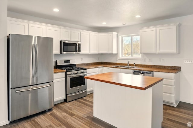 680 S Riverwalk Pkwy W, Logan, UT 84321 - kitchen with butcher block countertops, white cabinets, a sink, dark wood finished floors, and stainless steel appliances