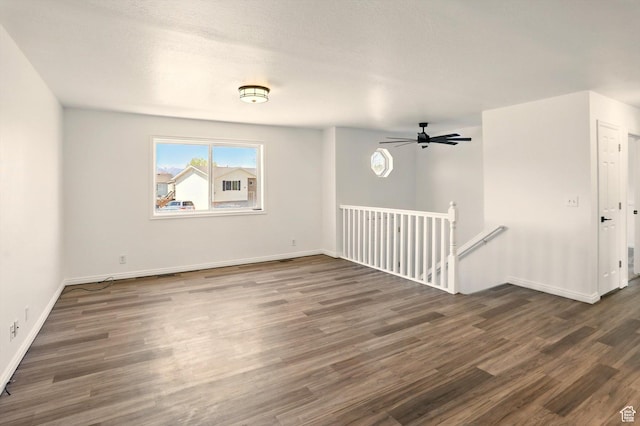 680 S Riverwalk Pkwy W, Logan, UT 84321 - empty room with baseboards, ceiling fan, and dark wood-type flooring