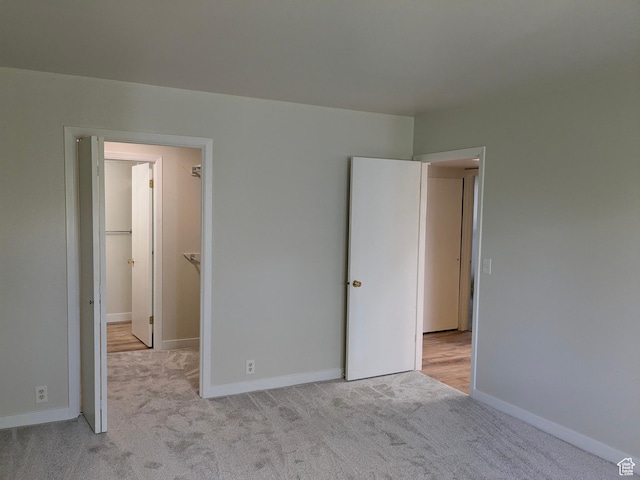 6871 N 2200 W Unit 8L, Park City, UT 84098 - unfurnished bedroom featuring baseboards, carpet flooring, and a walk in closet