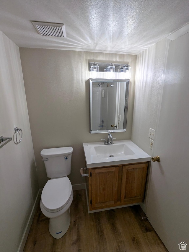 6871 N 2200 W Unit 8L, Park City, UT 84098 - bathroom featuring vanity, toilet, a textured ceiling, wood finished floors, and visible vents