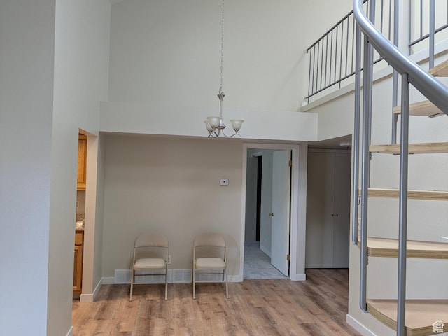 6871 N 2200 W Unit 8L, Park City, UT 84098 - interior space with a chandelier, wood finished floors, visible vents, and a towering ceiling