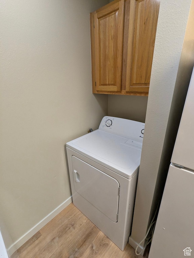 6871 N 2200 W Unit 8L, Park City, UT 84098 - washroom featuring washer / dryer, baseboards, cabinet space, and light wood-style flooring