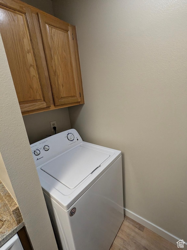 6871 N 2200 W Unit 8L, Park City, UT 84098 - laundry room with cabinet space, baseboards, washer / dryer, and light wood-style flooring