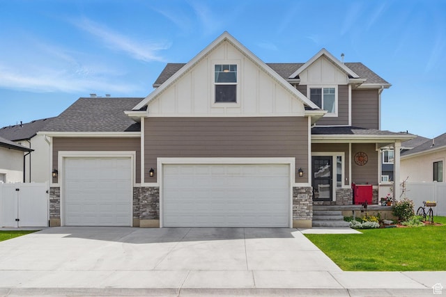 2471 W Anne Ave, West Haven, UT 84401 - craftsman-style house with board and batten siding, an attached garage, driveway, and stone siding