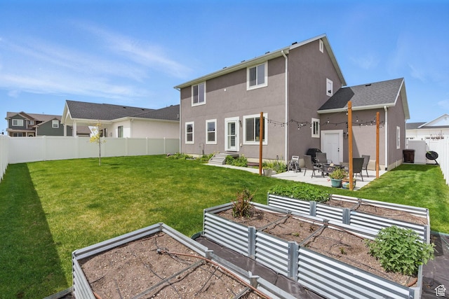 2471 W Anne Ave, West Haven, UT 84401 - back of house with a garden, a lawn, a fenced backyard, a patio, and stucco siding