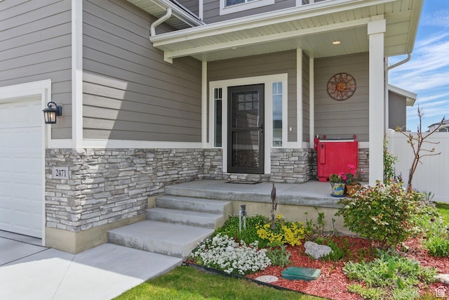 2471 W Anne Ave, West Haven, UT 84401 - property entrance featuring a porch, an attached garage, and stone siding