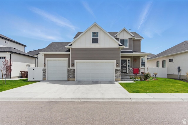 2471 W Anne Ave, West Haven, UT 84401 - craftsman-style home with board and batten siding, a front lawn, concrete driveway, an attached garage, and stone siding