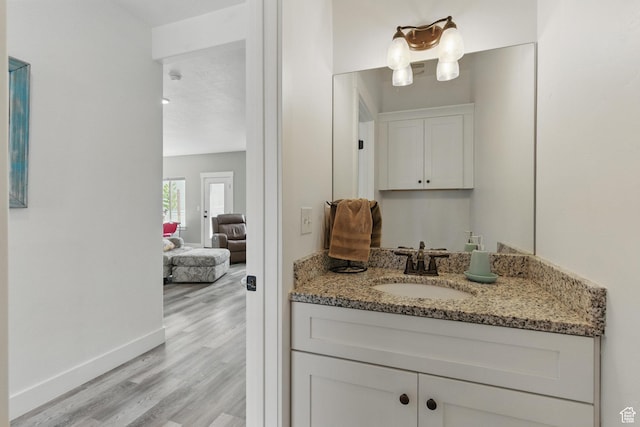 2471 W Anne Ave, West Haven, UT 84401 - bathroom with baseboards, wood finished floors, and vanity