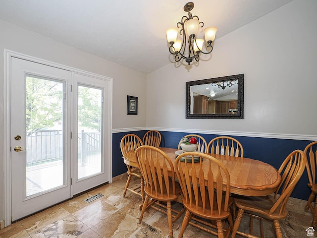 2777 W 1100 N, Layton, UT 84041 - dining room featuring a chandelier, visible vents, wainscoting, stone tile flooring, and lofted ceiling