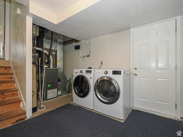 2777 W 1100 N, Layton, UT 84041 - clothes washing area with heating unit, laundry area, washing machine and dryer, and a textured ceiling