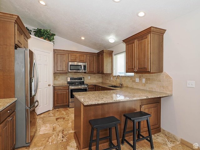 2777 W 1100 N, Layton, UT 84041 - kitchen featuring backsplash, appliances with stainless steel finishes, a sink, a peninsula, and lofted ceiling