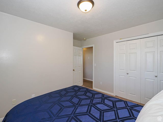 2777 W 1100 N, Layton, UT 84041 - unfurnished bedroom with a closet, a textured ceiling, and baseboards