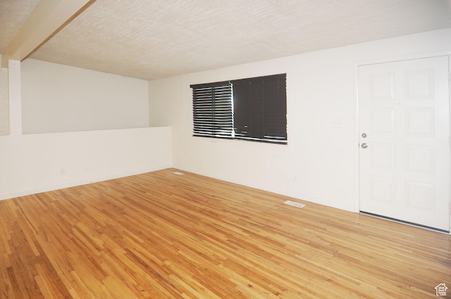 536 S Brinker E, Ogden, UT 84404 - spare room featuring a textured ceiling, baseboards, wood finished floors, and visible vents
