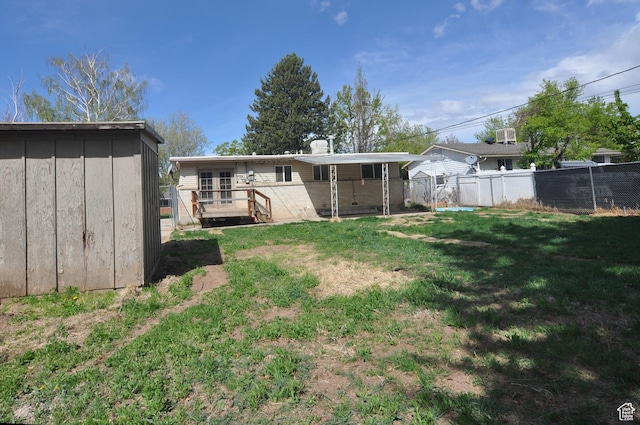 536 S Brinker E, Ogden, UT 84404 - back of house with fence, a storage shed, a deck, an outbuilding, and a lawn