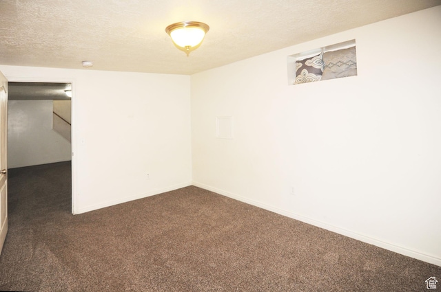 536 S Brinker E, Ogden, UT 84404 - empty room featuring baseboards, dark colored carpet, and a textured ceiling