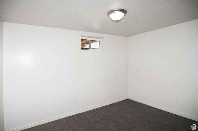 536 S Brinker E, Ogden, UT 84404 - basement with dark carpet, a textured ceiling, and baseboards