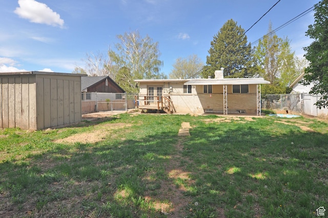 536 S Brinker E, Ogden, UT 84404 - rear view of property with a fenced backyard, a storage unit, a chimney, and a yard