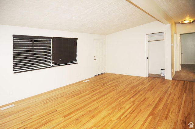 536 S Brinker E, Ogden, UT 84404 - empty room featuring visible vents, a textured ceiling, light wood-style flooring, and baseboards