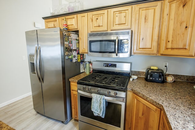 680 Stonne Ln, Kaysville, UT 84037 - kitchen with dark stone counters, baseboards, stainless steel appliances, and light wood-style flooring