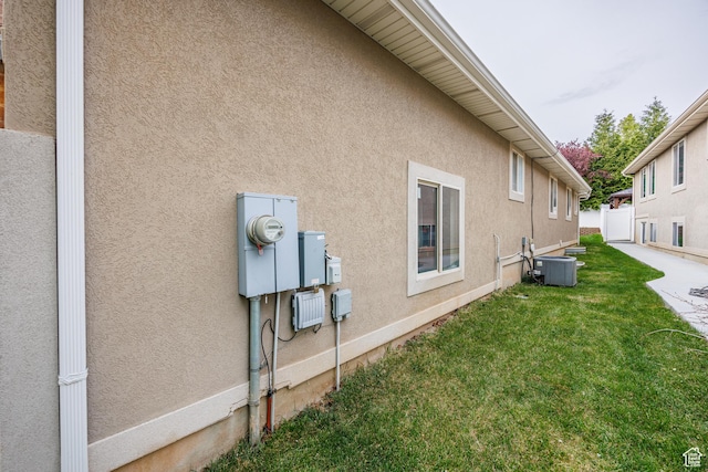 680 Stonne Ln, Kaysville, UT 84037 - view of home's exterior with a lawn, fence, central AC unit, and stucco siding